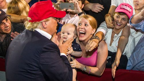 In this 2015 file photo, Donald Trump greets supporters at Ladd-Peebles Stadium in Mobile, Alabama.