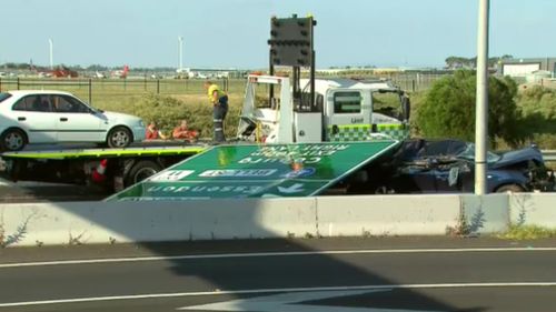 A woman has been taken to hospital after the overhead sign   fell onto a car below.