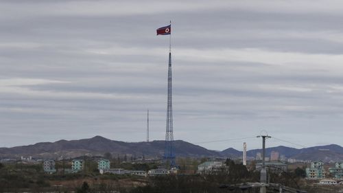 FILE - A North Korean flag flutters in the wind atop a 160-meter tower in North Korea's village Gijungdongseen, as seen from the Taesungdong freedom village inside the demilitarized zone in Paju, South Korea, on April 27, 2018. South Korea said Monday, Dec. 26, 2022, it fired warning shots after North Korean drones violated the Souths airspace.