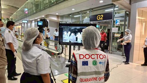 Quarantine doctors watch thermal scanning of travellers from west Bengal, India at the airport in Samut Prakarn, Thailand.