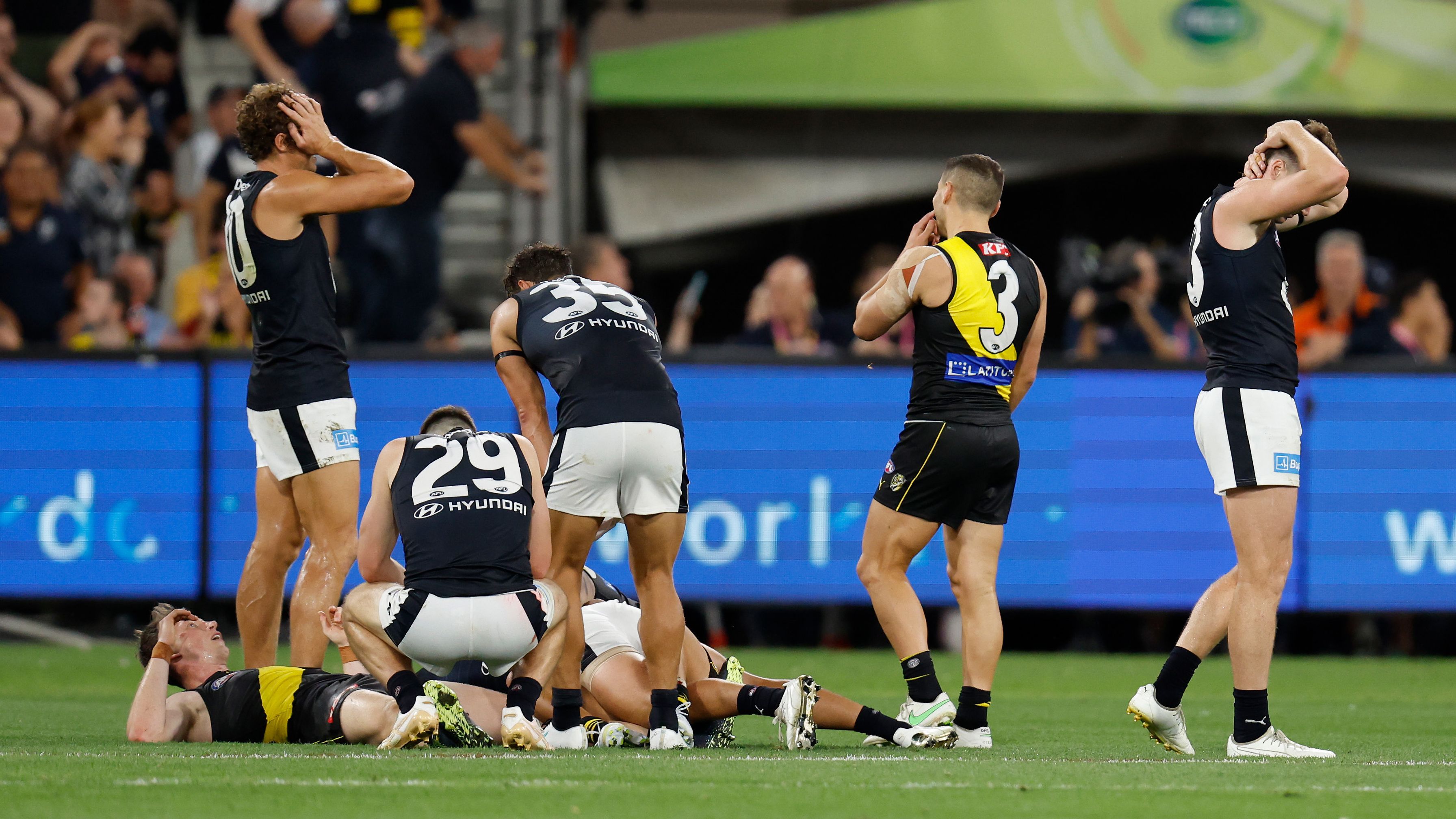MELBOURNE, AUSTRALIA - MARCH 16: Players react as the siren sounds to signal a draw during the 2023 AFL Round 01 match between the Richmond Tigers and the Carlton Blues at the Melbourne Cricket Ground on March 16, 2023 in Melbourne, Australia. (Photo by Michael Willson/AFL Photos)