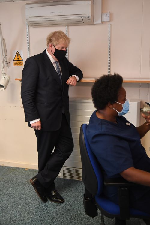 UK Prime Minister Boris Johnson wears a face mask as he visits Tollgate Medical Centre in Beckton 