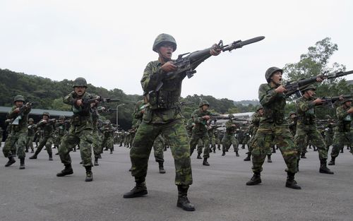 FILE - New recruits practice thrusting with their bayonets at a military training center in Hsinchu County, northern Taiwan on April 22, 2013. Taiwan will extend its compulsory military service from four months to a year starting in 2024, President Tsai Ing-wen said Tuesday, Dec. 27, 2022, as the self-ruled island faces China's military, diplomatic and trade pressure. (AP Photo/Chiang Ying-ying, File)