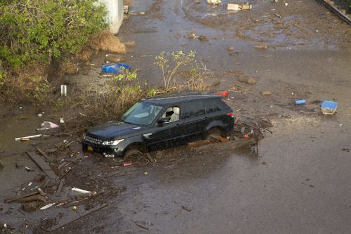 Cars were swept away by the force of the flash floods and mud. (AAP)