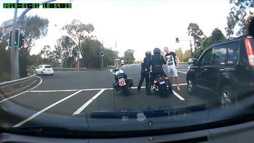It's at this point a second motorist intervenes, shouting "hey" to get the driver's attention, stepping in to separate the pair. (YouTube/Viralhog)