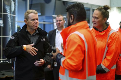 New Zealand Prime Minister Chris Hipkins, left, visits the Emergency Civil Defence Centre in Auckland, New Zealand, Tuesday, Feb. 14, 2023. 