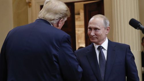 Presidents Donald Trump and Vladimir Putin shake hands. (AAP)