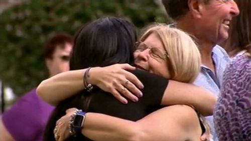 Faye Leveson embraces a mourner at Matthew's funeral.