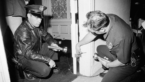 Police inspecting bullet holes in pantry Kennedy was fatally wounded inside. (AAP)