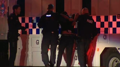 Some armed with knives turned on officers and damaged a police car. (9NEWS)