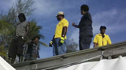 Police enter the detention centre on Thursday, ratcheting pressure on more than 300 asylum seekers to abandon the decommisioned camp. (Refugee Action Coalition/AP)