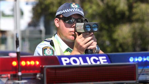 A NSW police officer zeroes his speed camera on cars