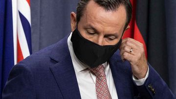 WA Premier Mark McGowan takes off his mask.