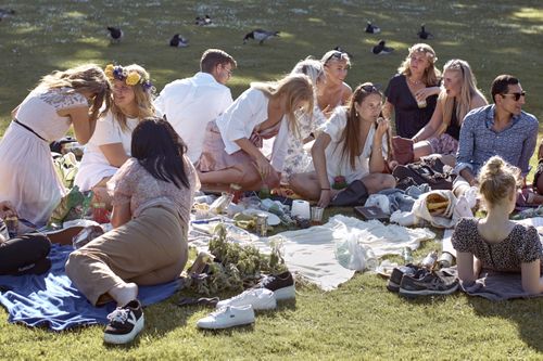 People picnic in June during the annual Midsummer celebrations in Stockholm, Sweden