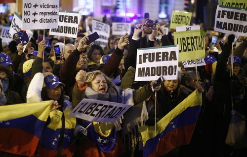 People in Spain protest against Venezuela's Nicolas Maduro and in support of an opposition leader self-proclaimed as the interim president of the country.