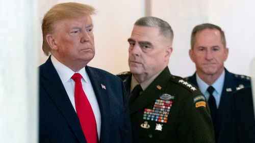 In this January 2020 photo, then president Donald Trump arrives to address the nation from the White House on the ballistic missile strike that Iran launched against Iraqi air bases housing U.S. troops, in Washington, accompanied by then Joint Chiefs Chairman Gen. Mark Milley, center, and US Air Force Chief of Staff Gen. David L. Goldfein.