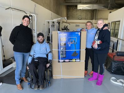 Molly (far right) with her physiotherapist Ryan Medley (second from left) who is a quadriplegic. 