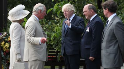  Prince Charles, Prince of Wales and Camilla, Duchess of Cornwall speak Prime Minister Boris Johnson and Defence Secretary Ben Wallace at the national service of remembrance marking the 75th anniversary of VJ Day at the National Memorial Arboretum on August 15, 2020 in Alrewas, England. 