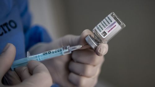 A healthcare worker of the Italian Army prepares doses of the AstraZeneca COVID-19 vaccine.