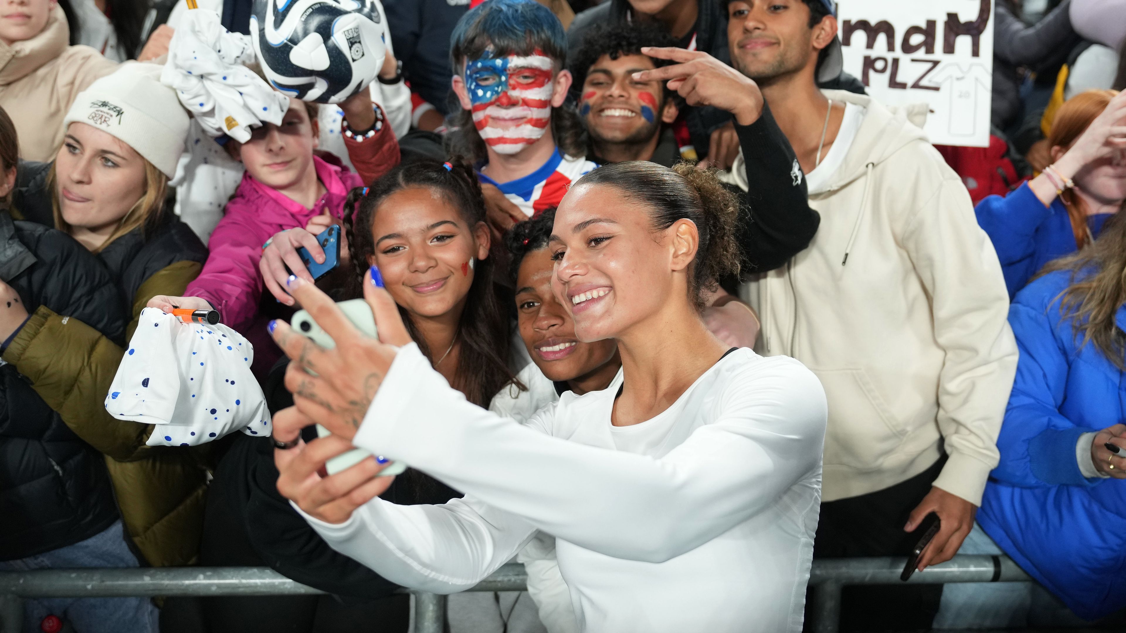 Trinity Rodman of the United States takes selfies with fans after losing to Portugal.