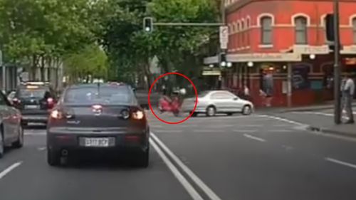 The motorcyclist hit the passenger side of the car as he travelled down Harris Street. (9NEWS)