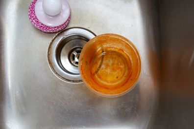 An old stained plastic food storage container
