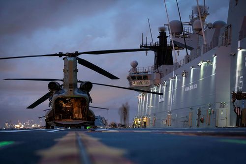 HMAS Adelaide embarks Australian Army CH-47 Chinook Heavy-Lift Helicopters before departing the port of Brisbane, to provide humanitarian assistance to the Government of Tonga.