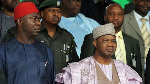 Nigeria's Vice President Namadi Sambo (R) and Deputy President of the Senate Ike Ekweremadu stand for the national anthem during the national inter-denominational funeral rites of Nigeria's secessionist leader Odumegwu Ojukwu at Michael Opkara Square in Enugu, southeastern Nigeria, on March 1, 2012. Soldiers fired a 21-gun salute at the funeral of Odumegwu Ojukwu on Thursday as Nigerian leaders paid final respects to the man whose 1967 declaration of Biafran independence sparked a civil war. For