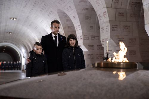 Macron with two young students pays his respect at the Douaumont Ossuary.