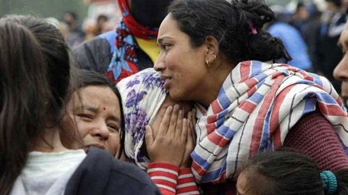 Family members of earthquake victim mourn during an early morning ceremony, a day after a massive earthquake in Kathmandu. (AP)