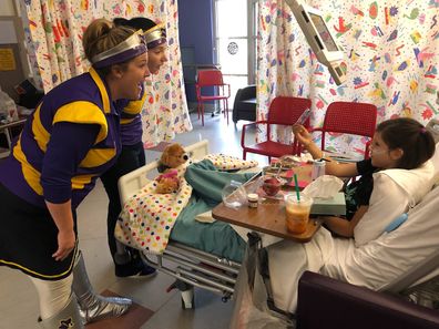 Lorelei being visited by the Starlight captains in hospital during dialysis. 