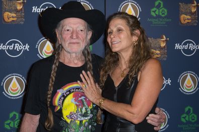 Willie Nelson and Annie D'Angelo attend Hard Rock International's Wille Nelson Artist Spotlight Benefit Concert at Hard Rock Cafe, Times Square on June 6, 2013 in New York City. 