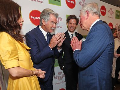 Charles greets Anna Friel, Pierce Brosnan and James Norton at the Prince's Trust Awards.