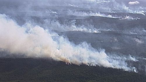 Out of control blaze burning through Happy Valley community on Fraser Island.