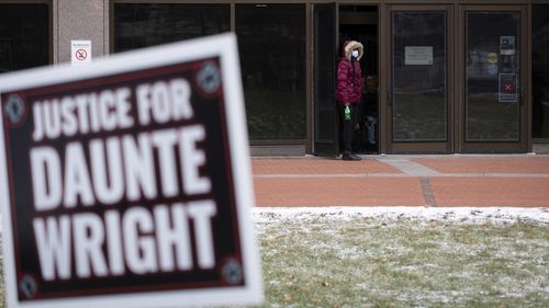 Activists watch the trial of former Brooklyn Center police Officer Kim Potter, Friday Dec. 17, 2021, outside the Hennepin County Courthouse in Minneapolis. Potter, who is white, is charged with first- and second-degree manslaughter in the shooting of Daunte Wright, a Black motorist, in the suburb of Brooklyn Center. Potter has said she meant to use her Taser  but grabbed her handgun instead  after Wright tried to drive away as officers were trying to arrest him. (AP Photo/Christian Monterrosa)