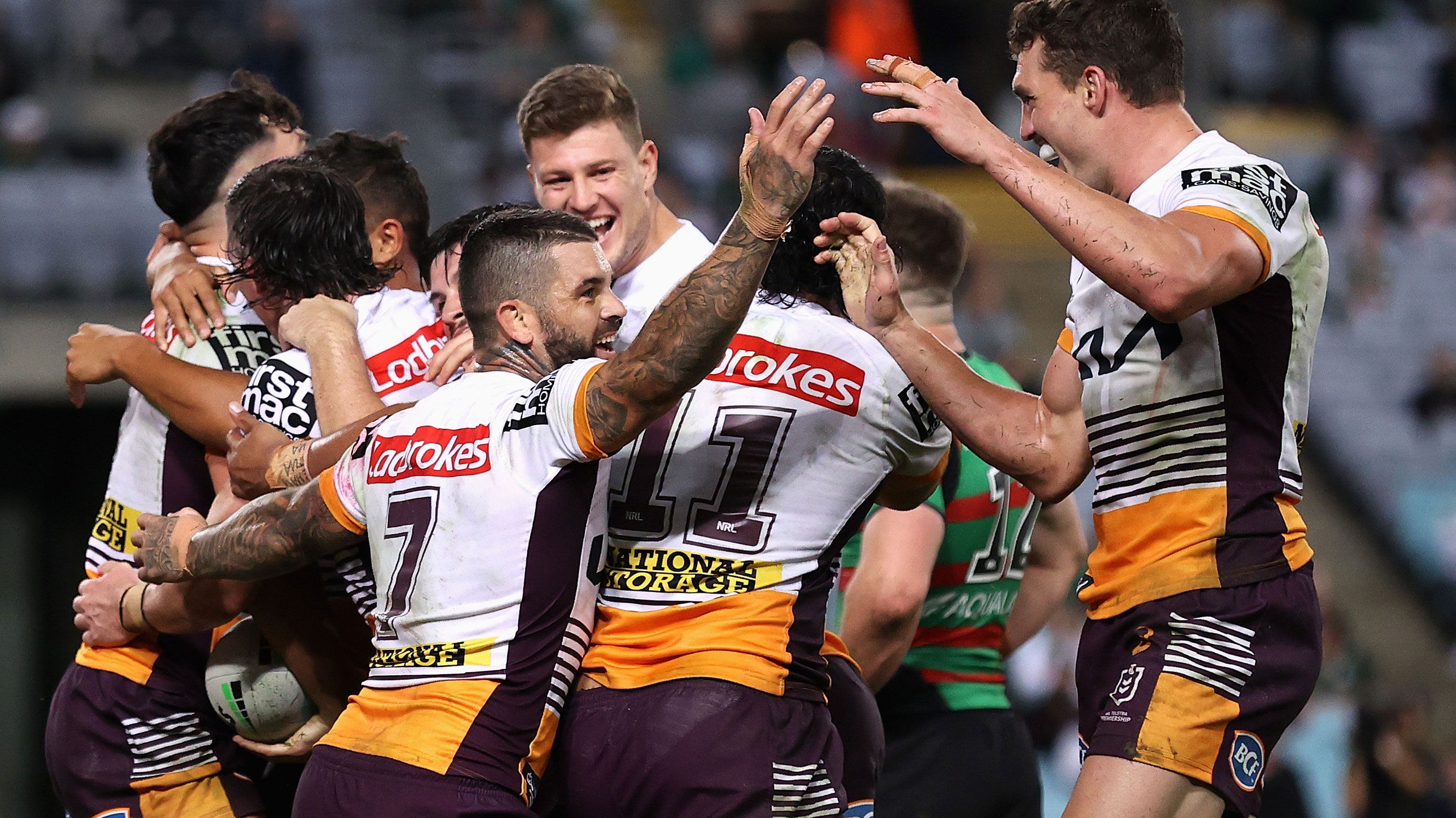 Herbie Farnworth of the Broncos celebrates a try with teammates during their round nine win over the Rabbitohs.
