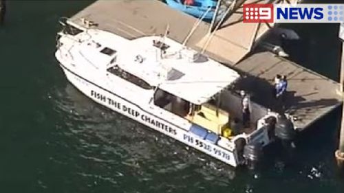 A charter boat near an ambulance at the The Spit. (9NEWS)