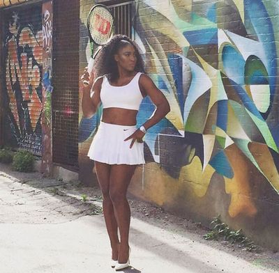 Serena strikes a pose in a daringtwo-piece tennis outfit.
