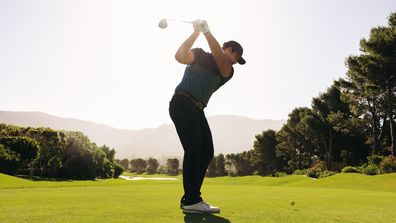 A man playing golf on a golf course