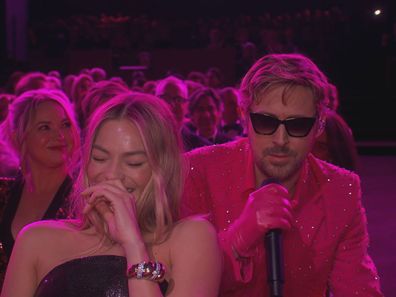 Ryan Gosling performs 'I'm Just Ken' to a laughing Margot Robbie at the Oscars.