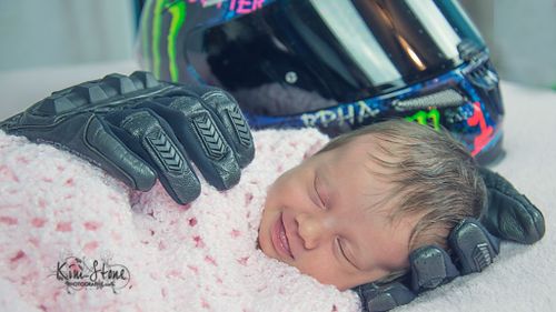 Touching photograph of baby cradled in late father’s motorcycle gloves goes viral