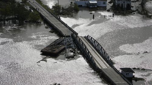 A barge damages a bridge that divides Lafitte, La., and Jean Lafitte, in the aftermath of Hurricane Ida, Monday, Aug. 30, 2021, in La. (AP Photo/David J. Phillip)