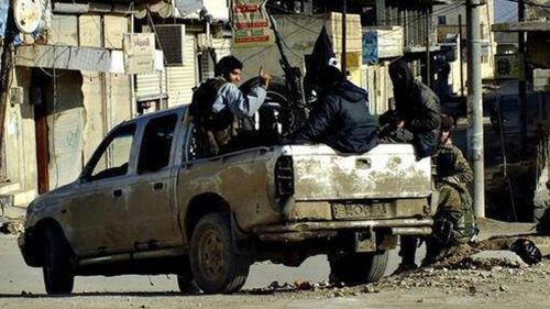 Fighters from the al-Qaeda linked Islamic State of Iraq and the Levant (ISIL) patrolling in Raqqa, Syria. (AAP)