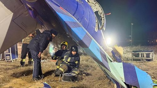 In this photo released by Kazakhstan's Emergency Ministry Press Service, rescuers work at the wreckage of Azerbaijan Airlines Embraer 190 lies on the ground near the airport of Aktau, Kazakhstan, Thursday, Dec. 26, 2024. (Kazakhstan's Emergency Ministry Press Service via AP)