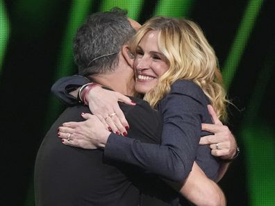 Dave Matthews, left, and Julia Roberts embrace during the 39th Annual Rock & Roll Hall of Fame Induction Ceremony on Saturday, Oct. 19, 2024, at Rocket Mortgage FieldHouse in Cleveland. (AP Photo/Chris Pizzello)