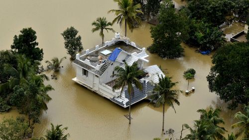 A house is partially submerged in flood waters in Chengannur in the southern state of Kerala, India.