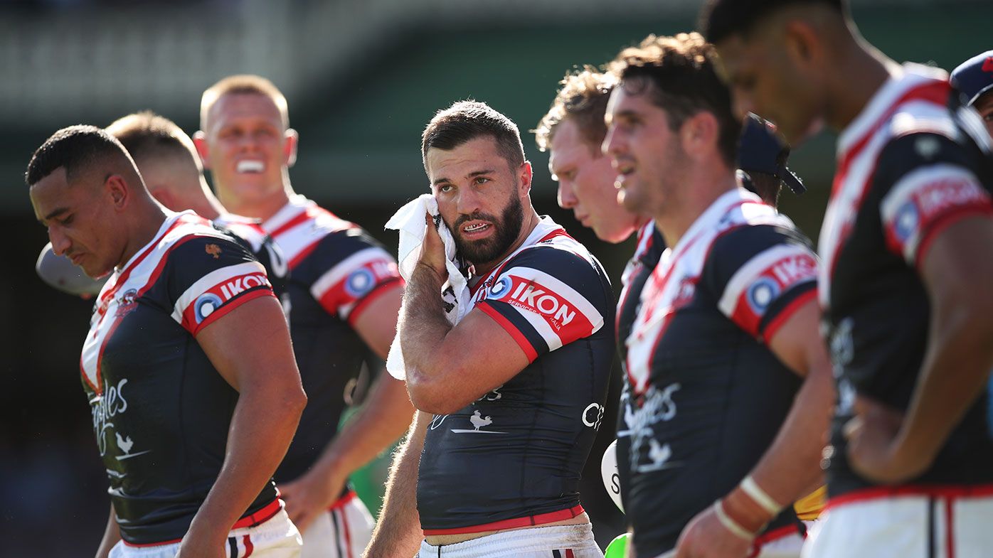 James Tedesco of the Roosters and team mates look dejected 