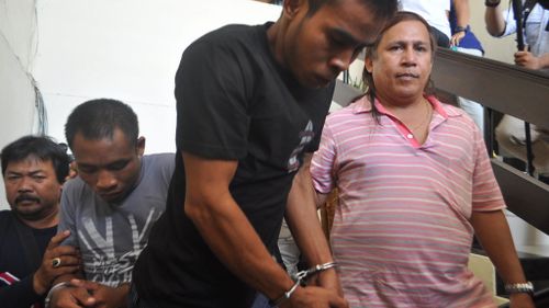 Urbanus Ghoghi (in grey shirt) and Yohanes Sairokodu (in black shirt) in the Crime Detective Directorate office in Bali. The pair have been arrested after a violent clash with police over their involvement in the murder of Robert Ellis. (AAP)