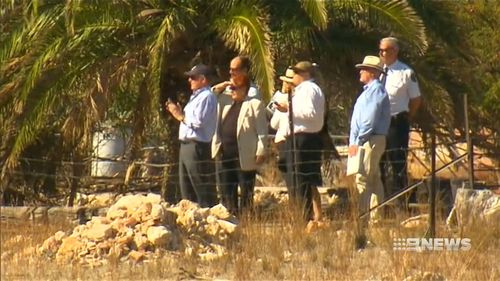 The deputy coroner and counsel assisting at the property. (9NEWS)