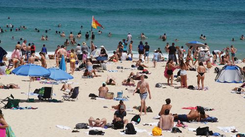 Beachgoers are see at Bondi Beach in Sydney during a major heatwave in January.